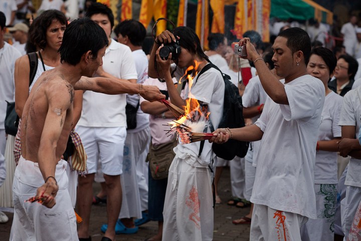 Ma Song performing a ritual with incense sticks.