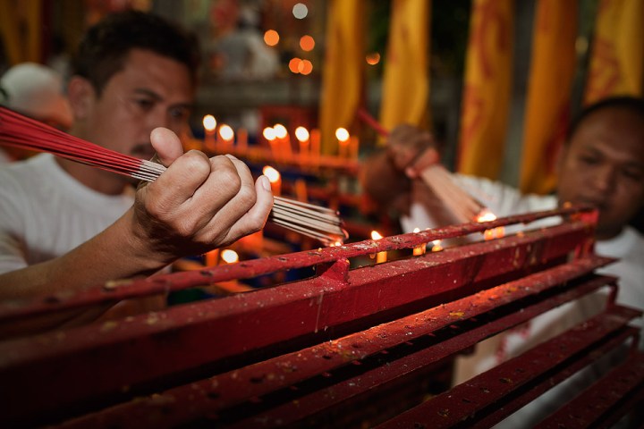 Phuket Vegetarian Festival - lighting incense.